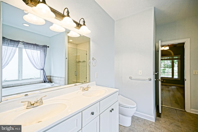 full bathroom featuring vanity, toilet, plus walk in shower, and a wealth of natural light