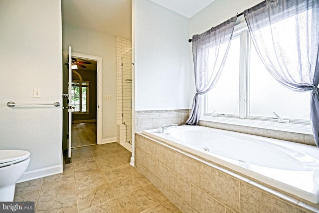 bathroom featuring ceiling fan, separate shower and tub, a healthy amount of sunlight, and toilet