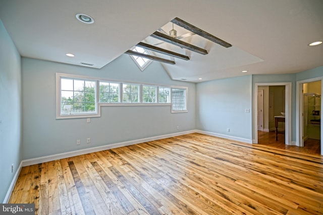 empty room with light hardwood / wood-style flooring and a skylight