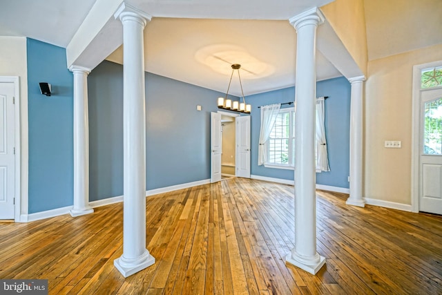 interior space with ornate columns, hardwood / wood-style flooring, and a wealth of natural light