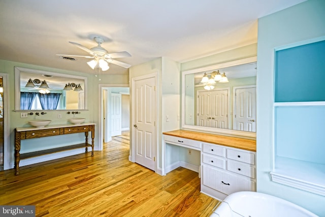 bathroom with vanity, hardwood / wood-style flooring, and ceiling fan with notable chandelier