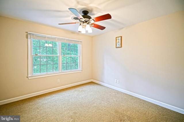 spare room with ceiling fan and carpet flooring