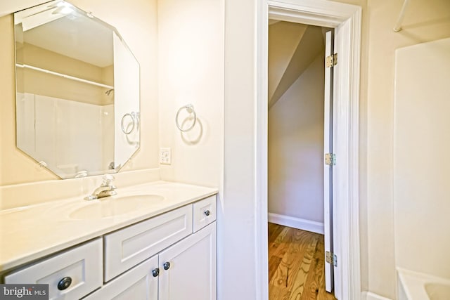 bathroom featuring vanity, hardwood / wood-style floors, and shower / bathtub combination