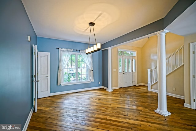 unfurnished dining area featuring decorative columns, dark hardwood / wood-style flooring, and plenty of natural light