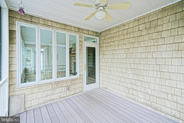 wooden deck featuring ceiling fan