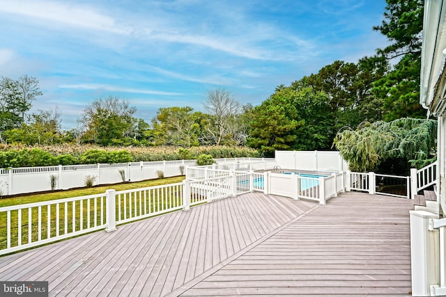 wooden terrace featuring a fenced in pool