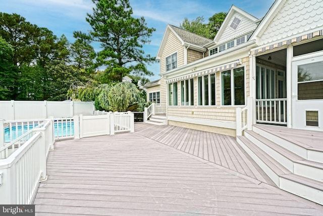 wooden terrace with a fenced in pool