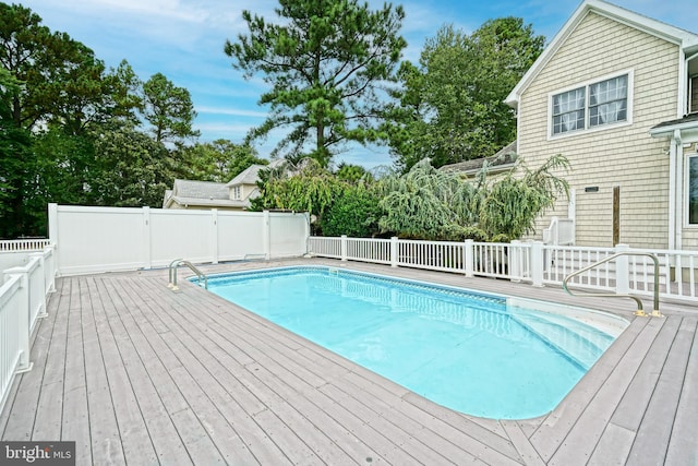 view of swimming pool with a wooden deck