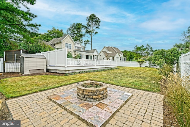 exterior space featuring a storage shed, a deck, and a fire pit