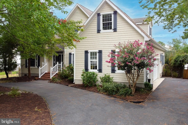 view of front of house with a garage and covered porch