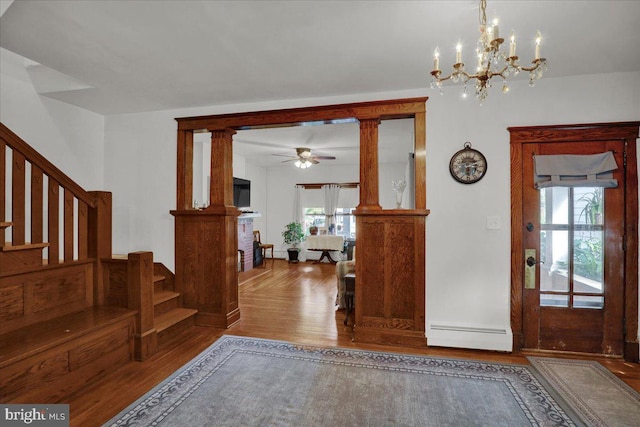 entrance foyer with hardwood / wood-style flooring, ceiling fan with notable chandelier, baseboard heating, and a wealth of natural light