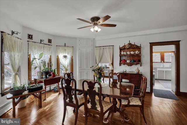 dining room with ceiling fan and sink