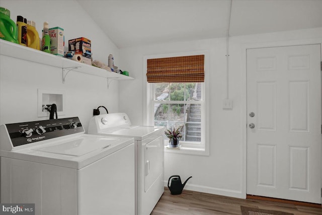 laundry area with washer and dryer and hardwood / wood-style flooring