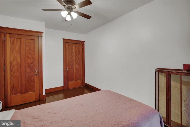 unfurnished bedroom featuring ceiling fan and dark wood-type flooring