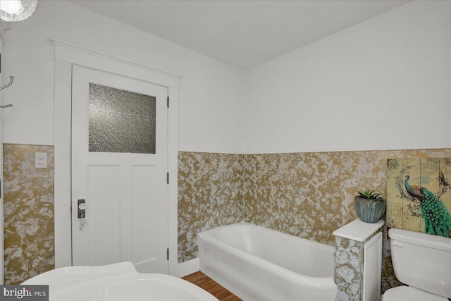 bathroom with a bathing tub and toilet