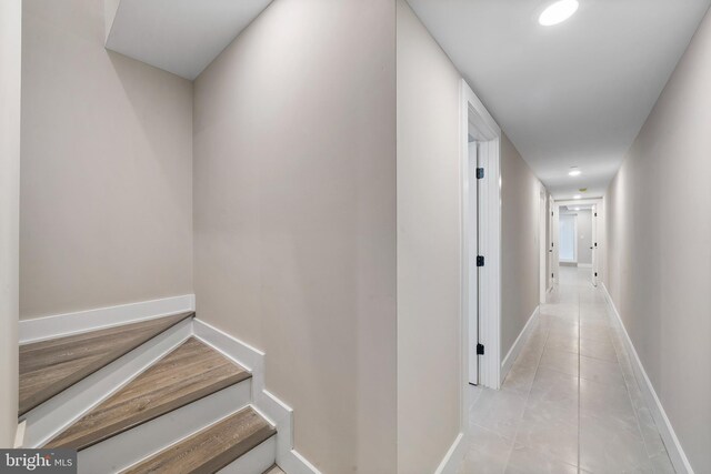 hall featuring light tile patterned floors