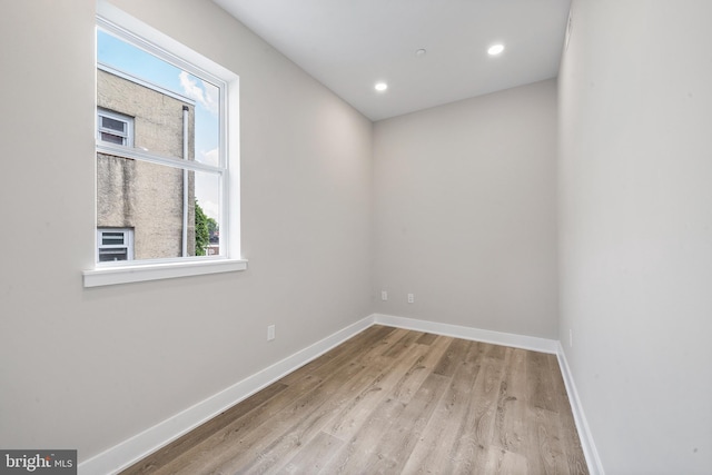 unfurnished room with light wood-type flooring