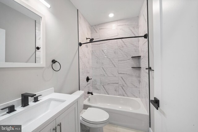 full bathroom featuring tile patterned flooring, vanity, toilet, and tiled shower / bath