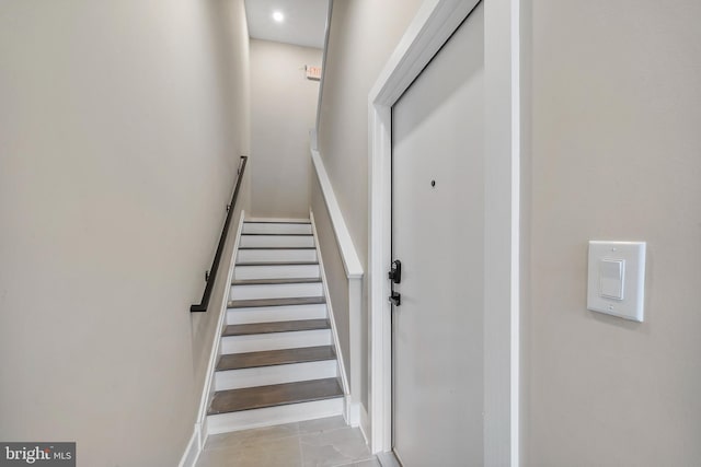 staircase with tile patterned floors