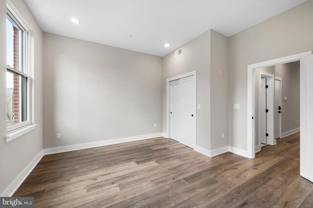 unfurnished room with dark hardwood / wood-style flooring and a wealth of natural light