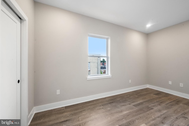 spare room with dark wood-type flooring