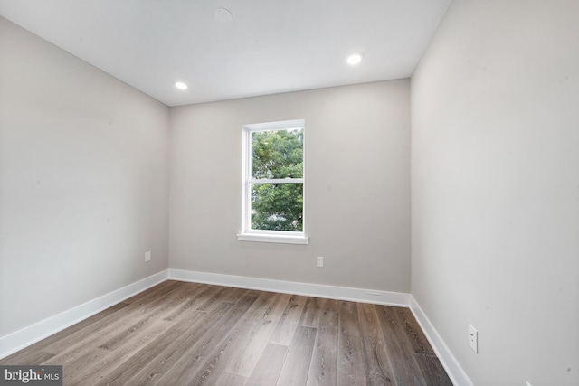 unfurnished room with hardwood / wood-style floors