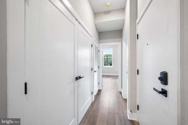 corridor with dark hardwood / wood-style flooring