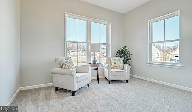 sitting room featuring light colored carpet and a healthy amount of sunlight