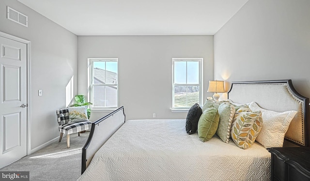 carpeted bedroom featuring multiple windows