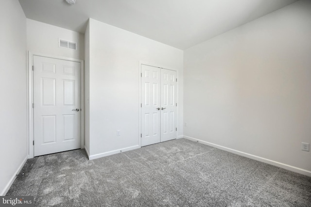 unfurnished bedroom featuring carpet and a closet