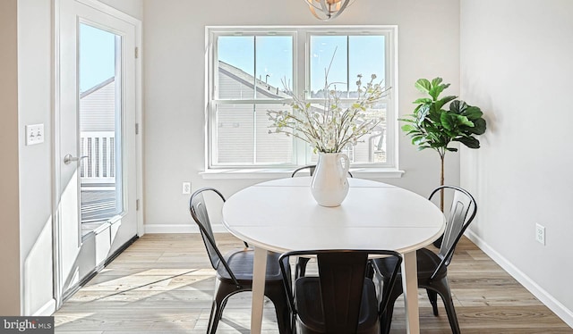 dining area with light hardwood / wood-style flooring and plenty of natural light