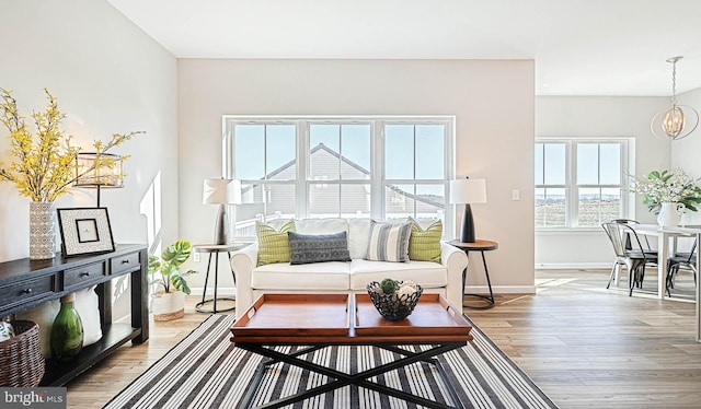 interior space featuring a chandelier and light hardwood / wood-style flooring