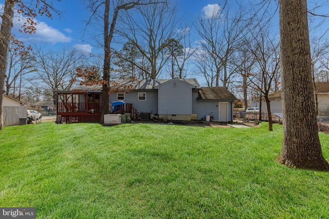 rear view of house featuring a yard, a shingled roof, crawl space, and a wooden deck