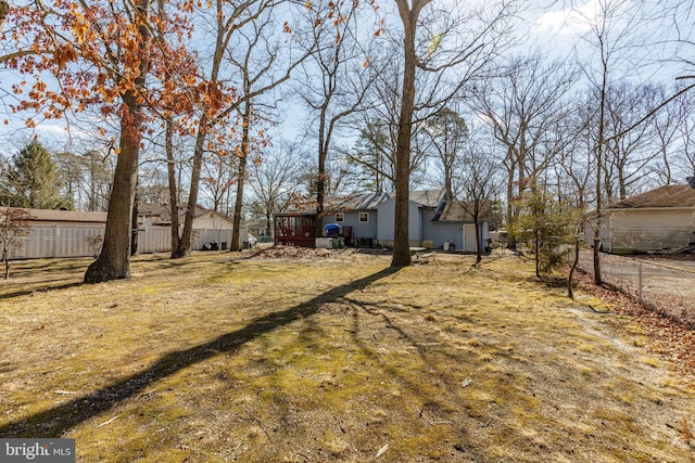 view of yard with fence and a deck