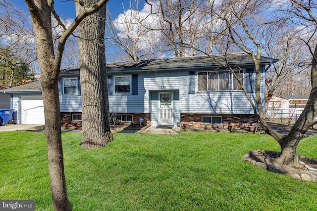 raised ranch with a front yard and an attached garage