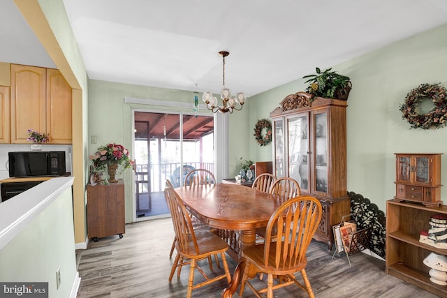 dining space with a chandelier and light wood-type flooring