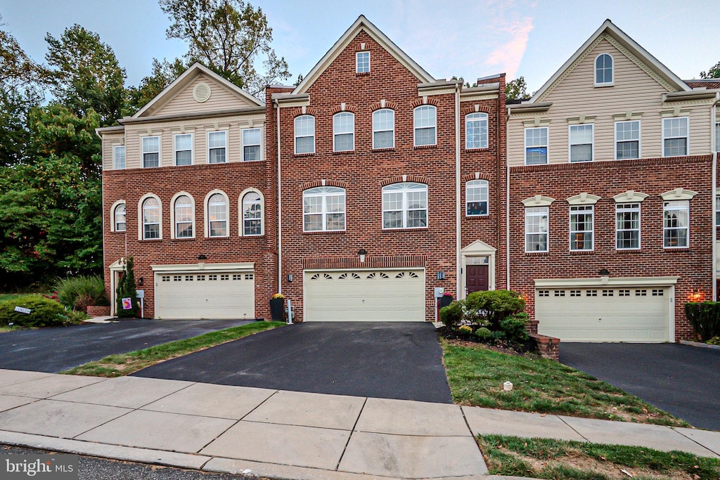 multi unit property featuring a garage