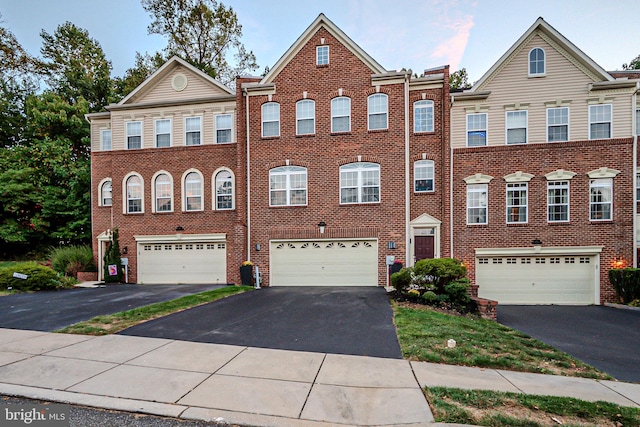 multi unit property featuring a garage