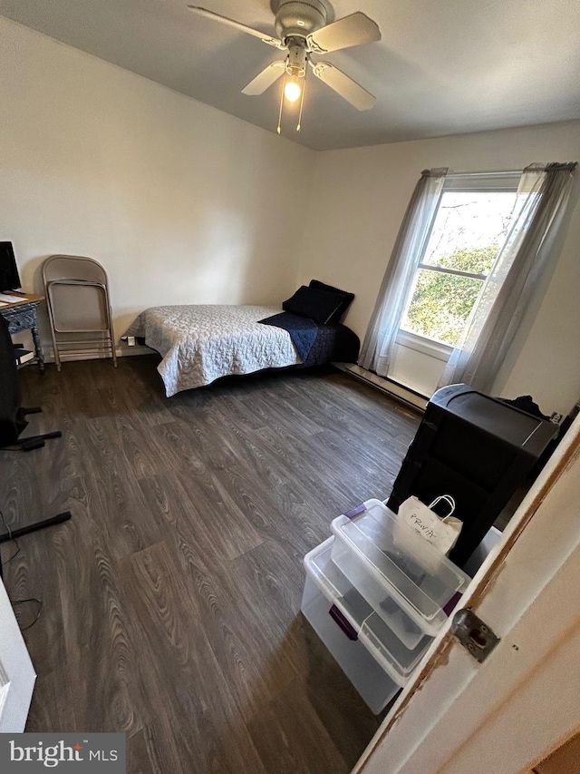 bedroom featuring a ceiling fan and dark wood-style flooring