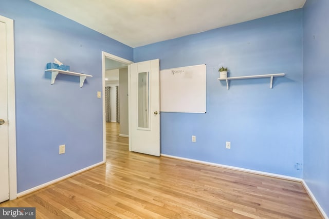 spare room with light hardwood / wood-style flooring