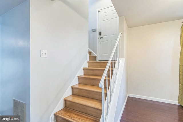 stairway with hardwood / wood-style flooring