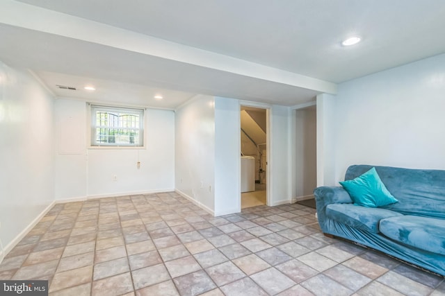 basement with washer / clothes dryer and ornamental molding