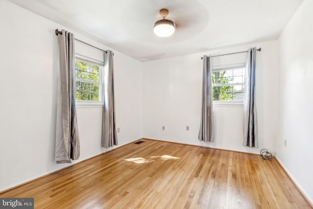 spare room with ceiling fan and light hardwood / wood-style flooring