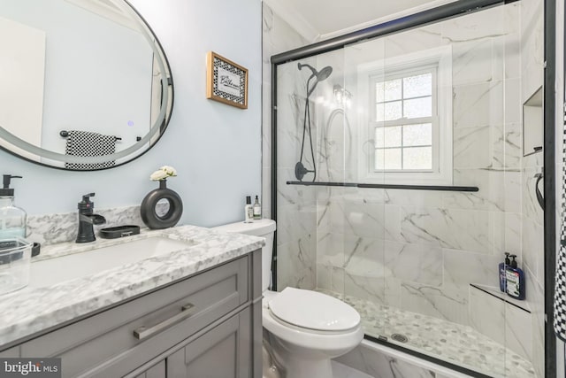 bathroom with crown molding, vanity, a shower with door, and toilet