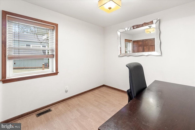 unfurnished office featuring light hardwood / wood-style floors