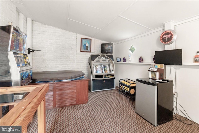 office featuring lofted ceiling and dark colored carpet