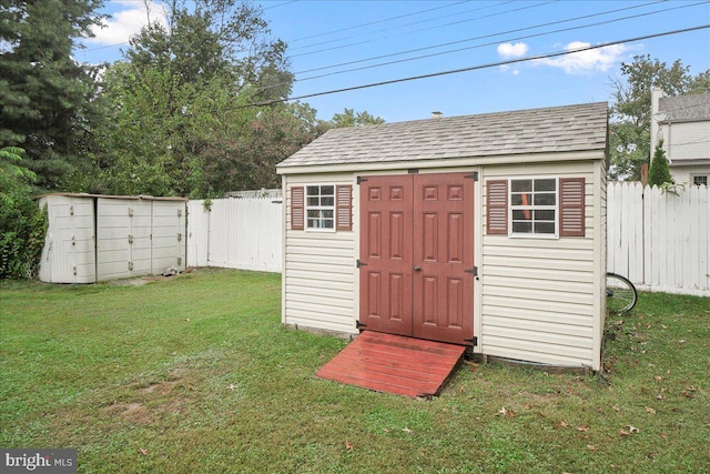 view of outbuilding featuring a lawn