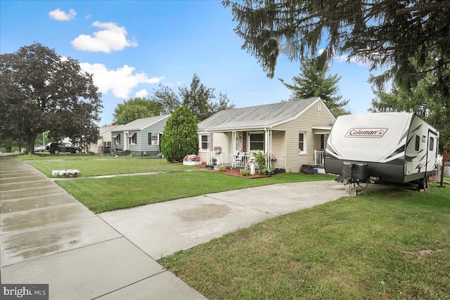 view of front of home with covered porch and a front yard