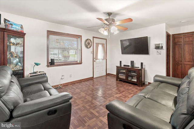 living room featuring dark parquet floors and ceiling fan