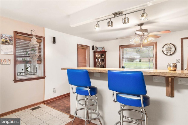 kitchen with ceiling fan and parquet flooring